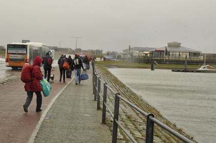 Deelnemers lopen van de boot naar restaurant de piraat